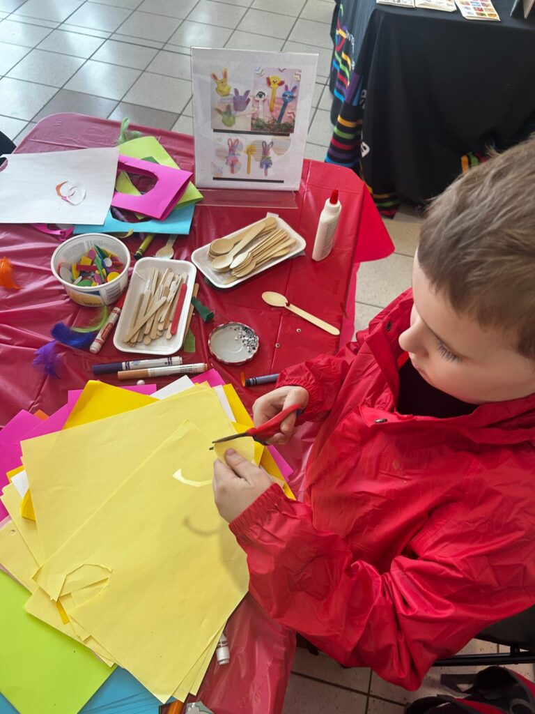 A child doing a craft project with coloured paper